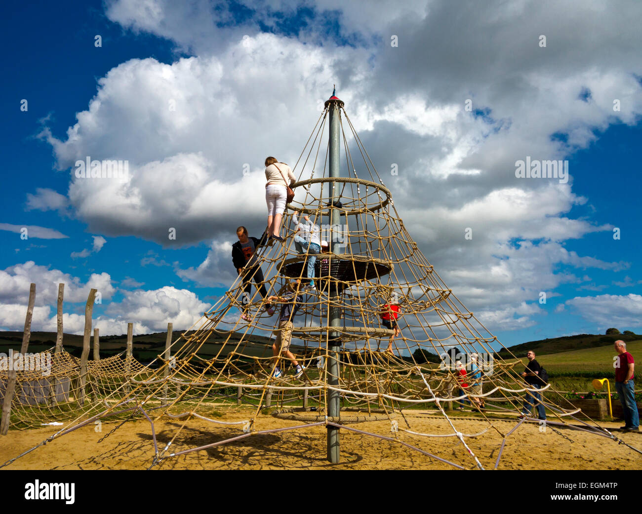 Children playing in a community playground designed by local teenagers in West Bay near Bridport in Dorset south west England UK Stock Photo