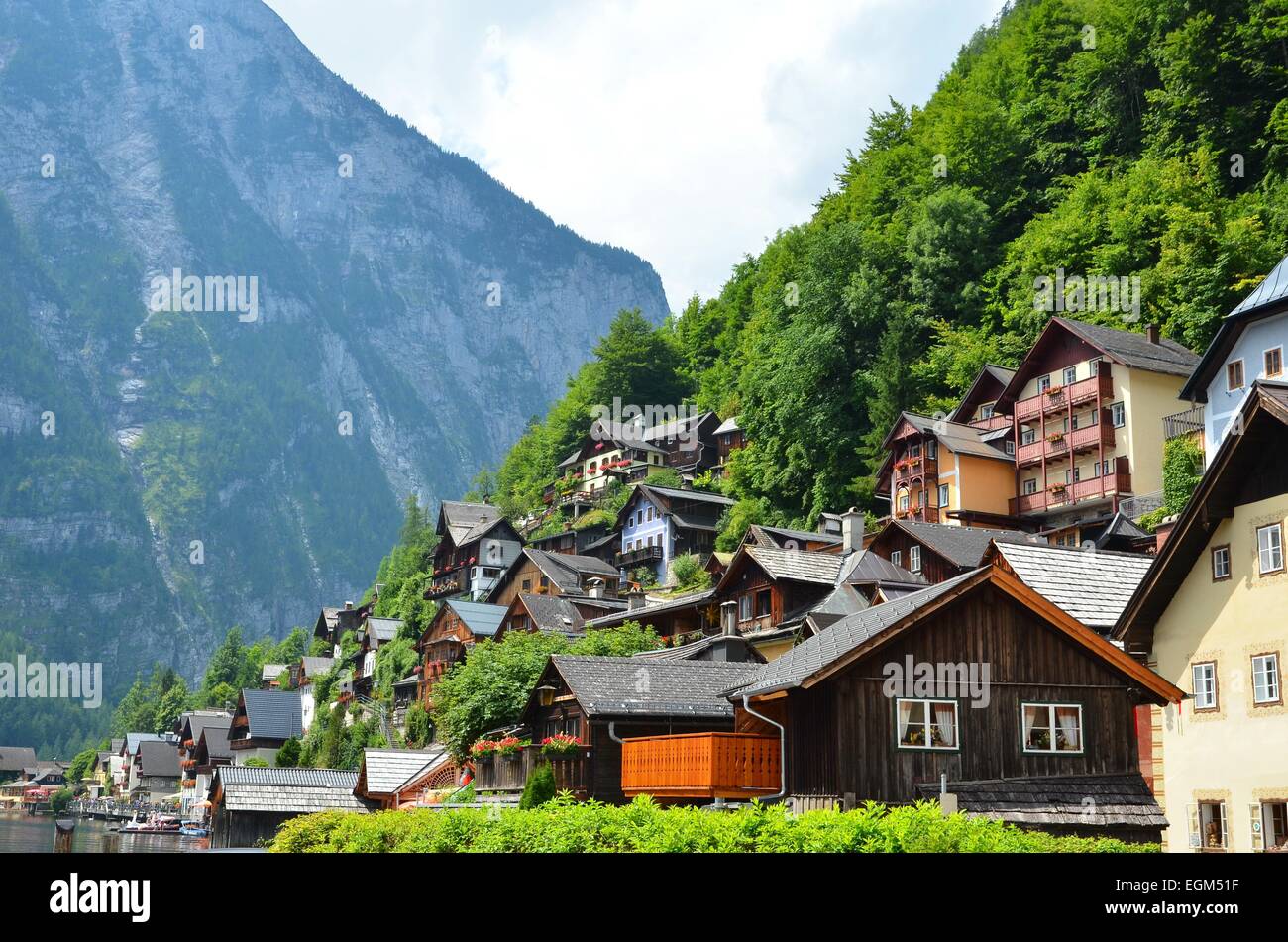 Image of famous alpine village Halstatt during colourful summer morning. Stock Photo