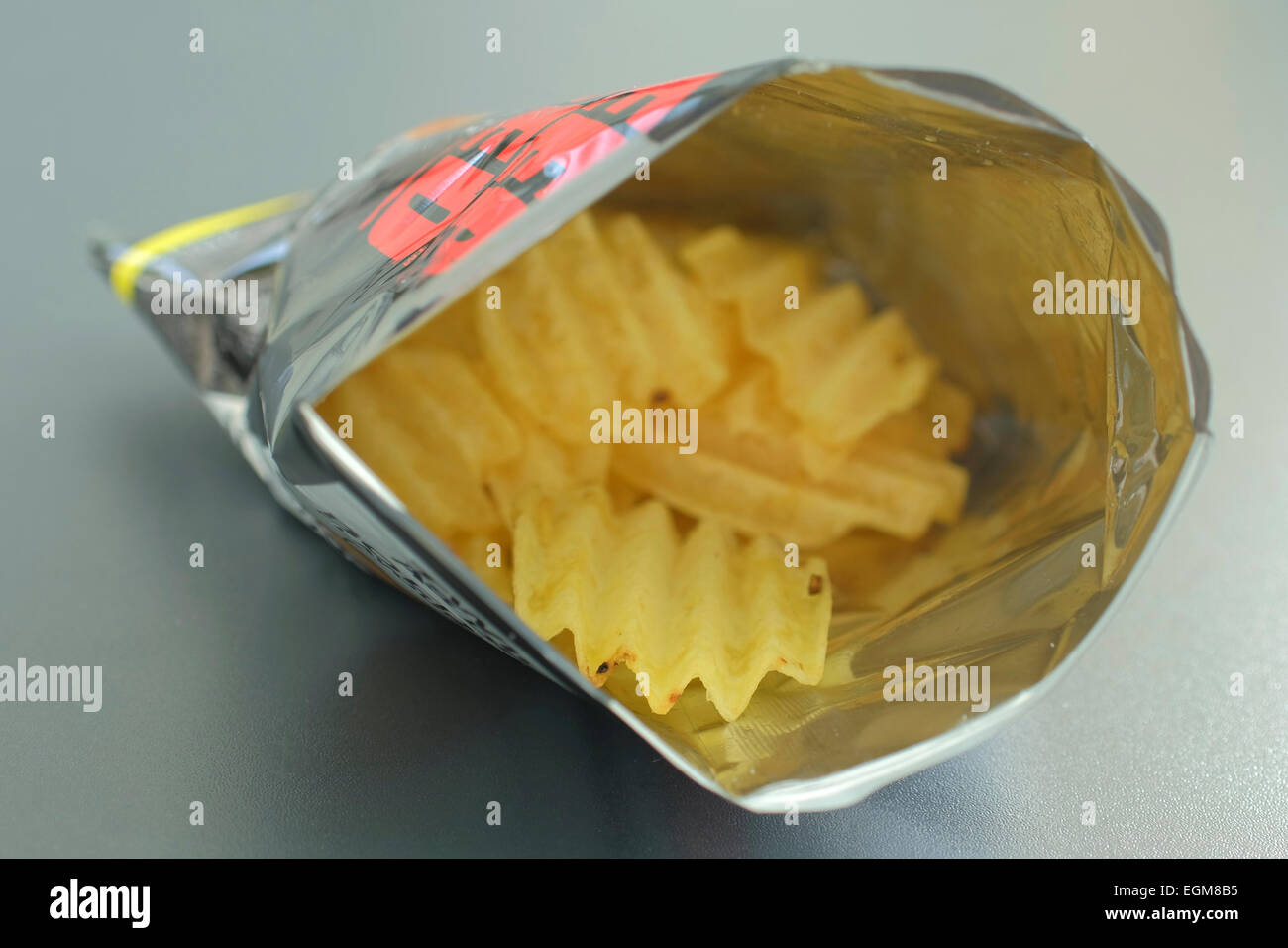 open packet of potato crisps Stock Photo