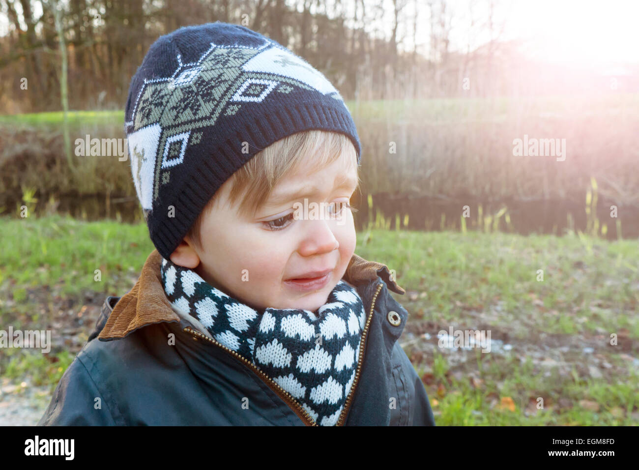 portrait of a crying toddler at sunset Stock Photo