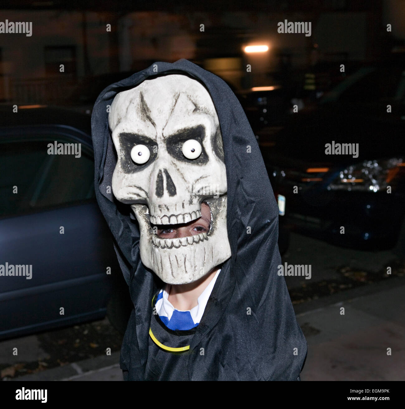 Giant Skull mask Trick or Treating Halloween Night Stock Photo