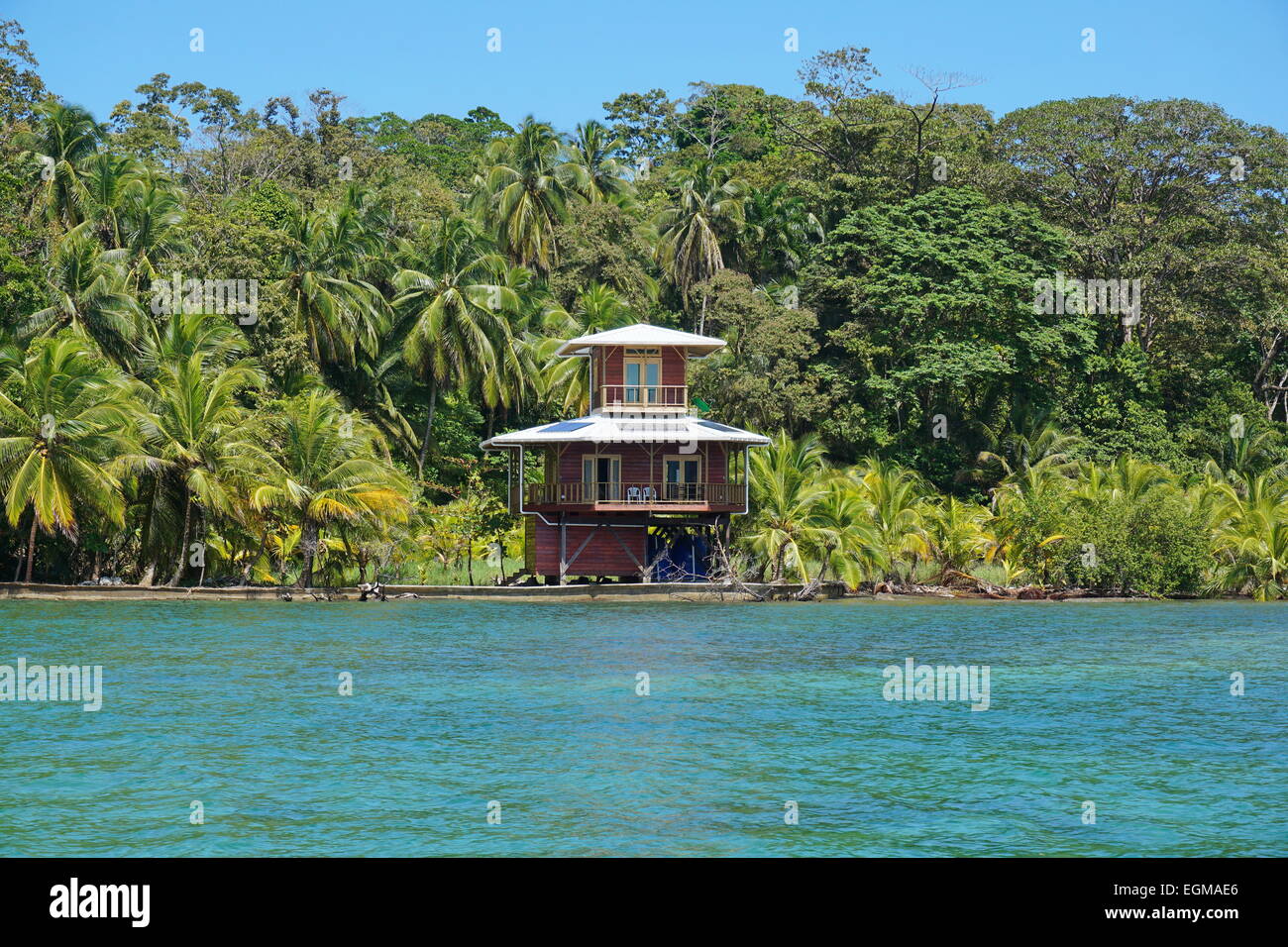 Waterfront tropical house and vegetation on the Caribbean island of Bastimentos, Bocas del Toro, Panama, Central America Stock Photo