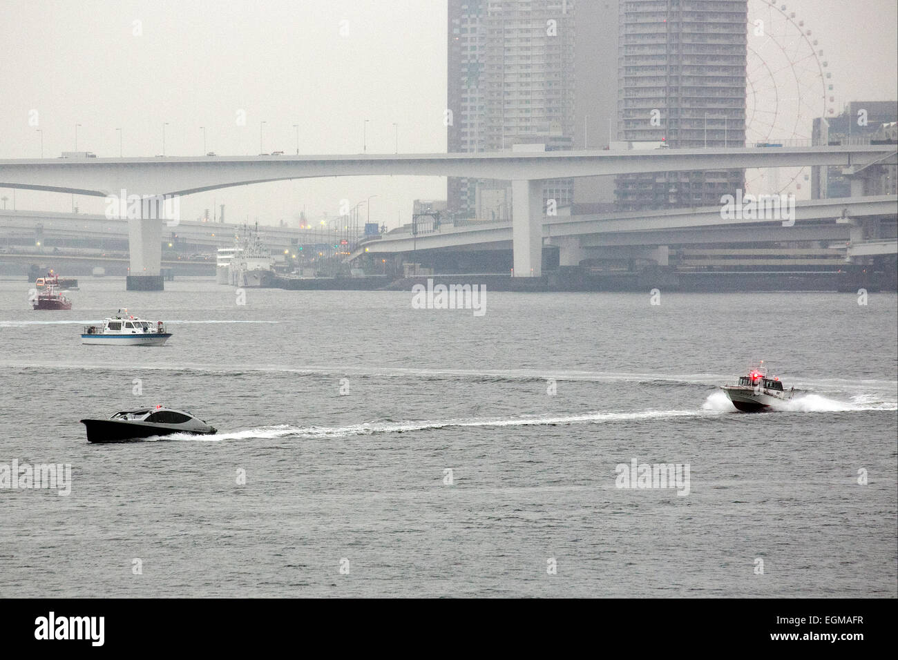 The Duke of Cambridge arrives in Tokyo by boat on February 26th, 2015. The Prince flew in to Tokyo International Airport on Thursday afternoon and then traveled to Tokyo city on a cruise boat to visit the historic Hama Rikyu gardens and a traditional Japanese tea house. He arrived on a rainy day but nevertheless Japanese TV crews were out to try to catch a glimpse of the Prince as his boat entered Tokyo Harbour and passed under the Rainbow Bridge. On his visit he will launch an Innovation is Great campaign and also travel to Ishinomaki in Miyagi Prefecture to meet people who were affected by t Stock Photo