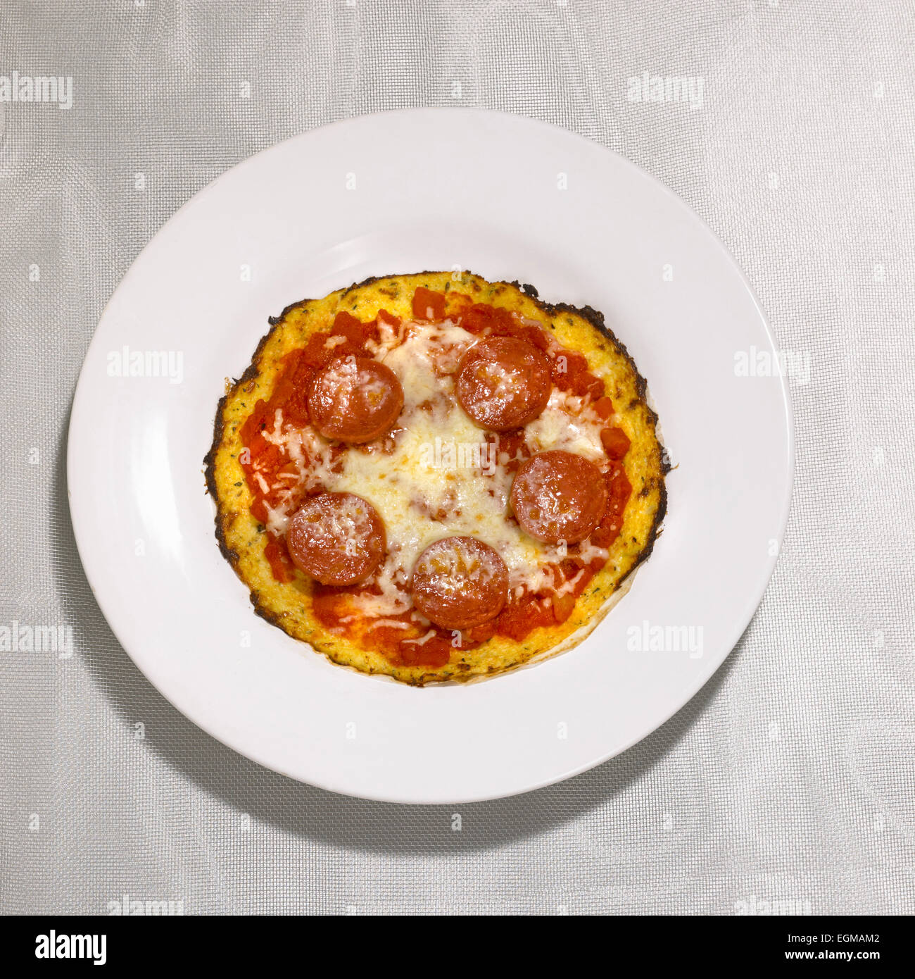Small Cauliflower Crust Pepperoni Pizza on Plate Stock Photo