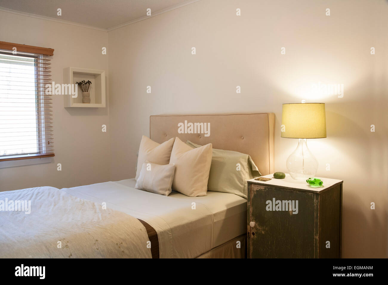 Small Bedroom With Double Bed Side Table And Lamp Stock