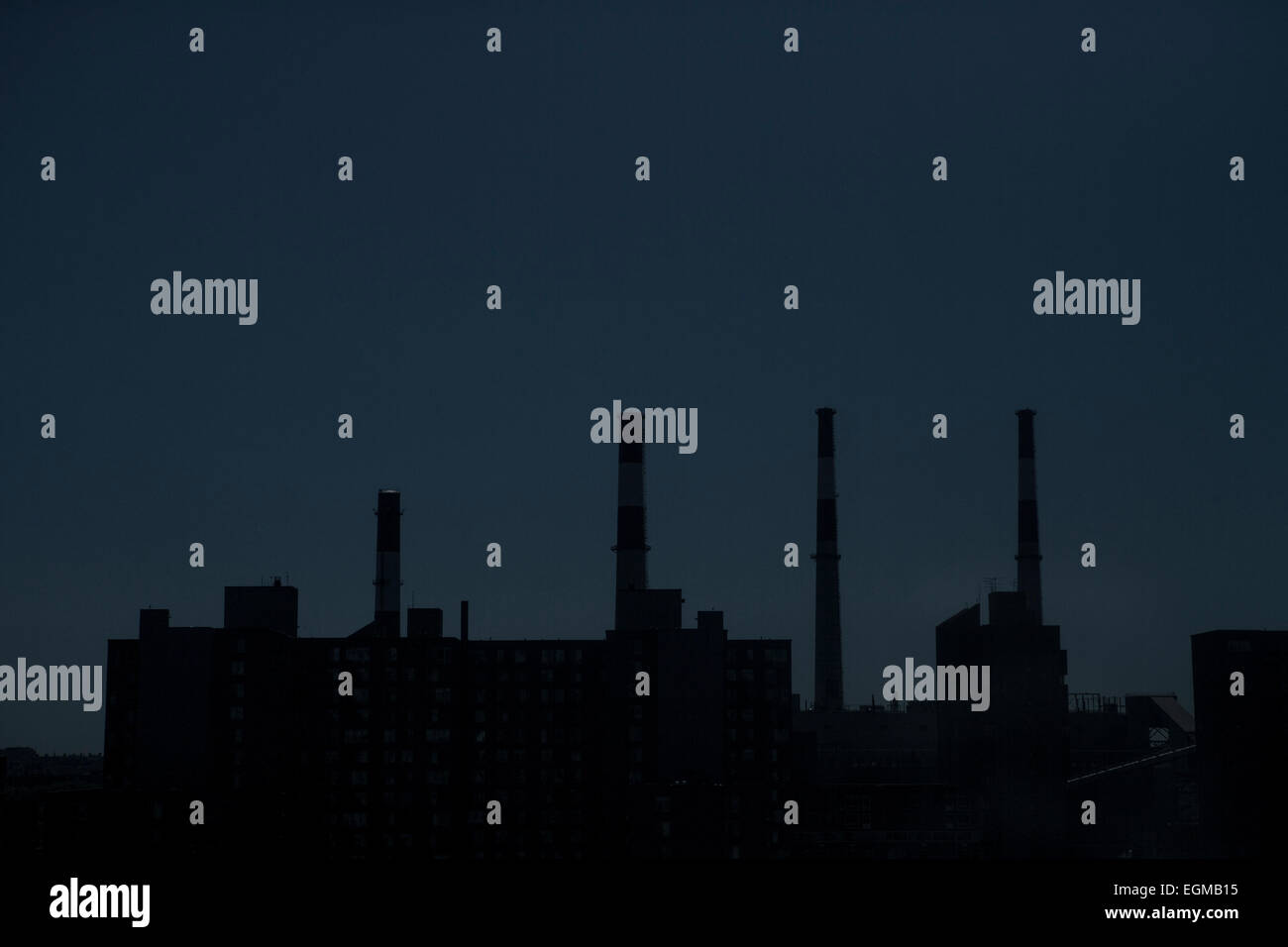 Eerie Power Station with Smoke Stacks at Night, New York City, USA Stock Photo