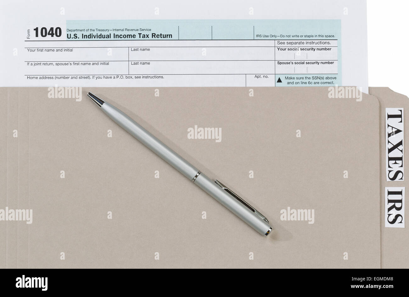 Individual tax form inside of gray folder with pen. Business