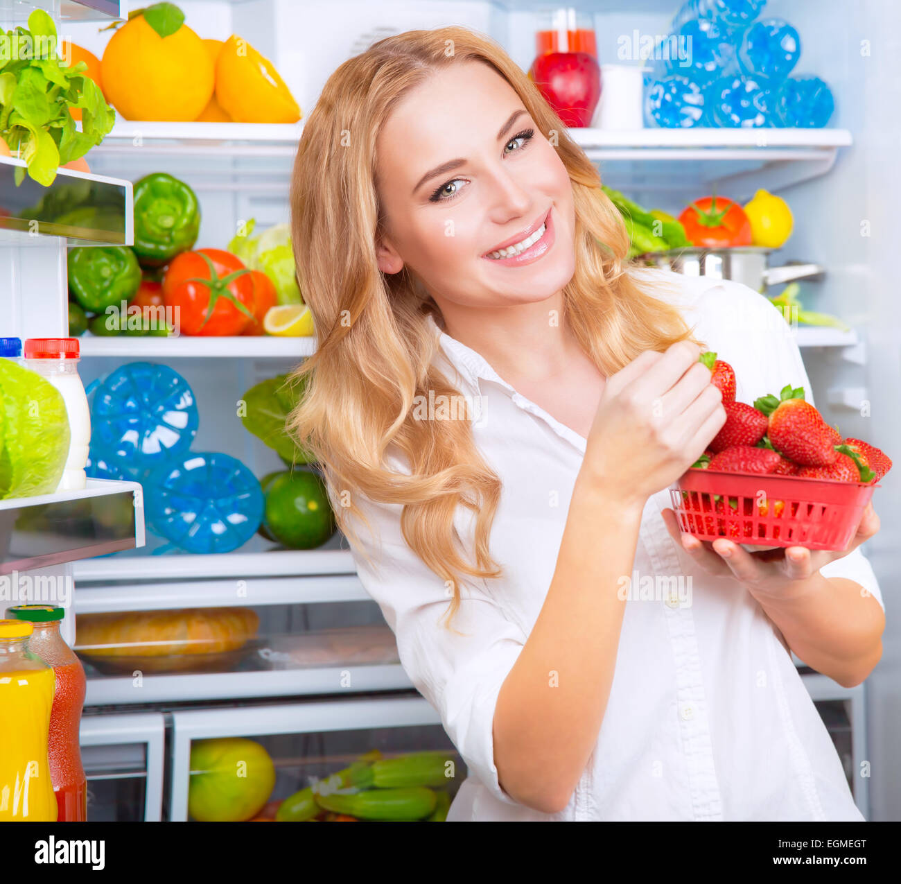 Refrigerator shelf with organic juicy strawberries in bio recycled paper  boxes and homemade natural milk yogurt. Fridge filled with berries in  cardboard containers. Healthy and eco friendly food diet Stock Photo by ©