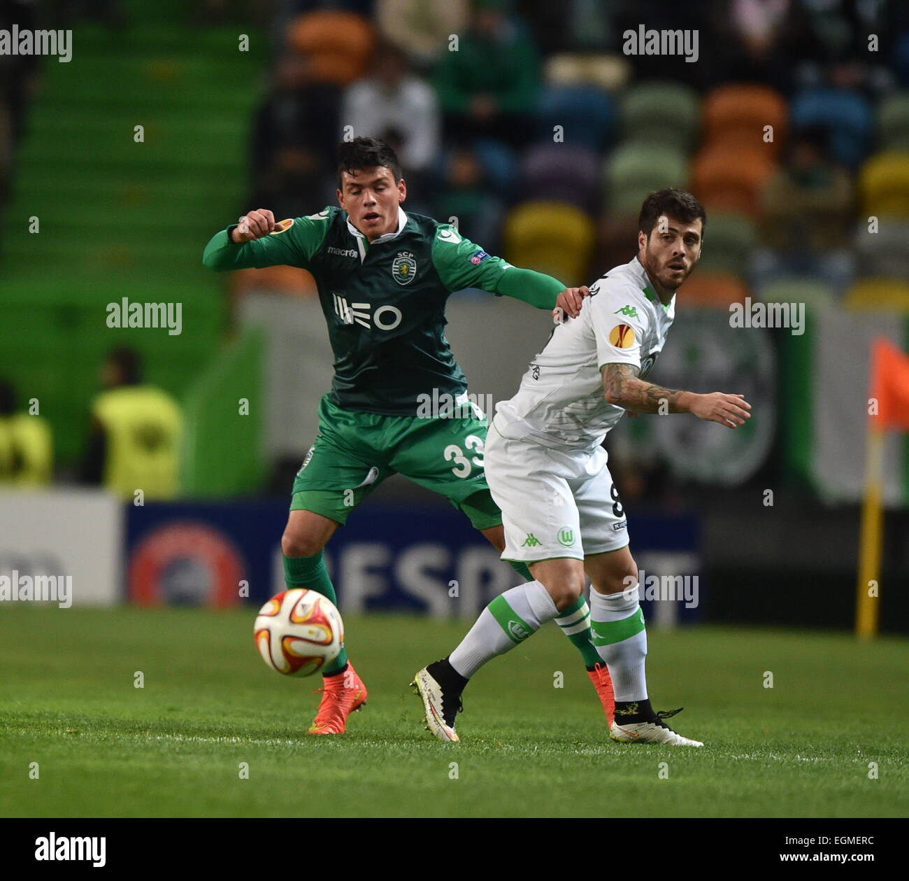 Lisbon. 26th Feb, 2015. Sporting's Jonathan Silva (L) vies for the ball with Wolfsburg's Vieirinha during the UEFA Europa League round of 32 second leg match between Sporting Clube de Portugal and VfL Wolfsburg at the Jose Alvalade stadium in Lisbon, Portugal on Feb. 26, 2015. Credit:  Zhang Liyun/Xinhua/Alamy Live News Stock Photo