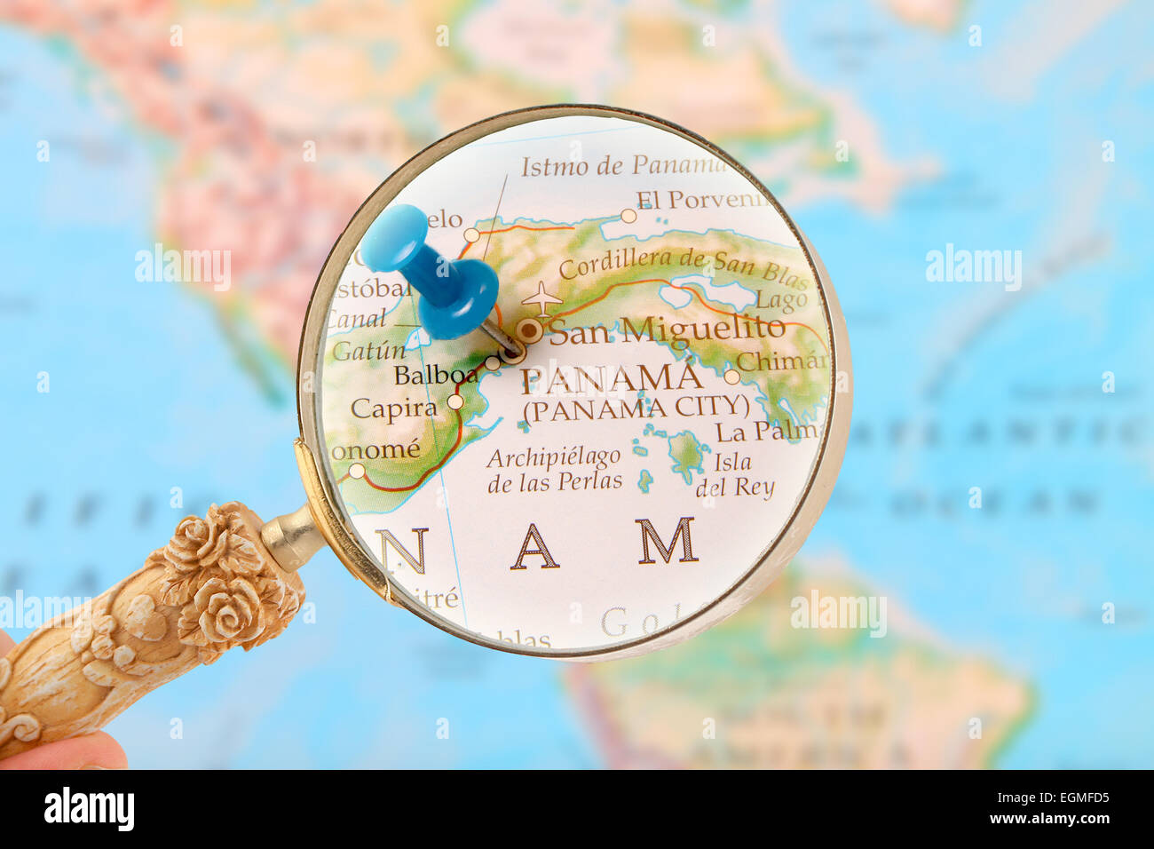 Blue tack on map with magnifying glass looking in on Panama City, Central America Stock Photo