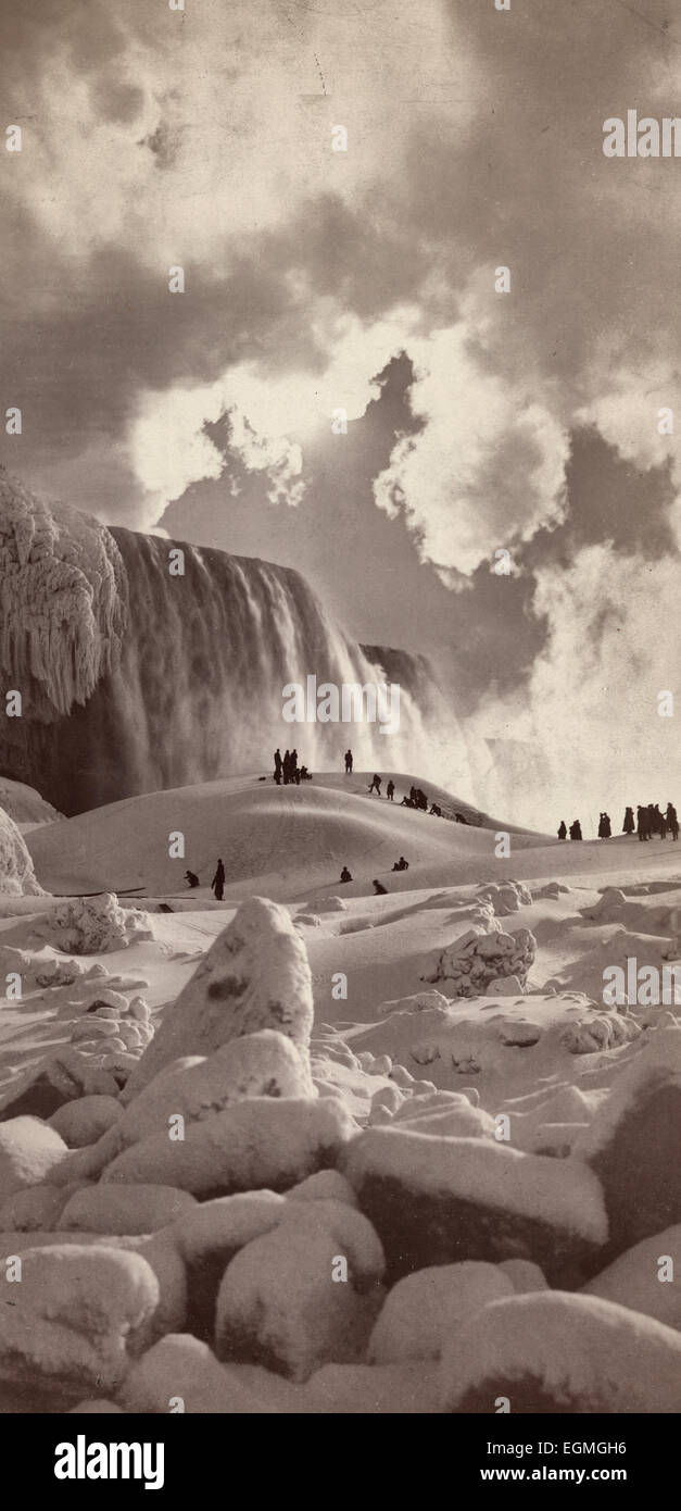 People on snow-covered ice at the base of the frozen American Falls, Niagara Falls, New York, circa 1883 Stock Photo