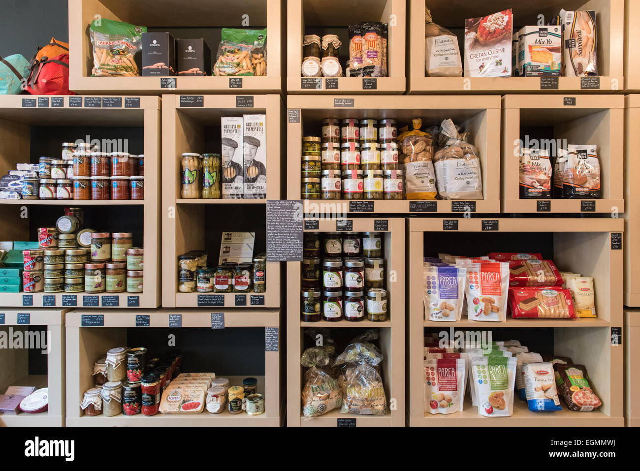 interior of posh luxury gourmet food and drink shop, showing the shelves packed with tasty food products like cheeses & jams etc Stock Photo