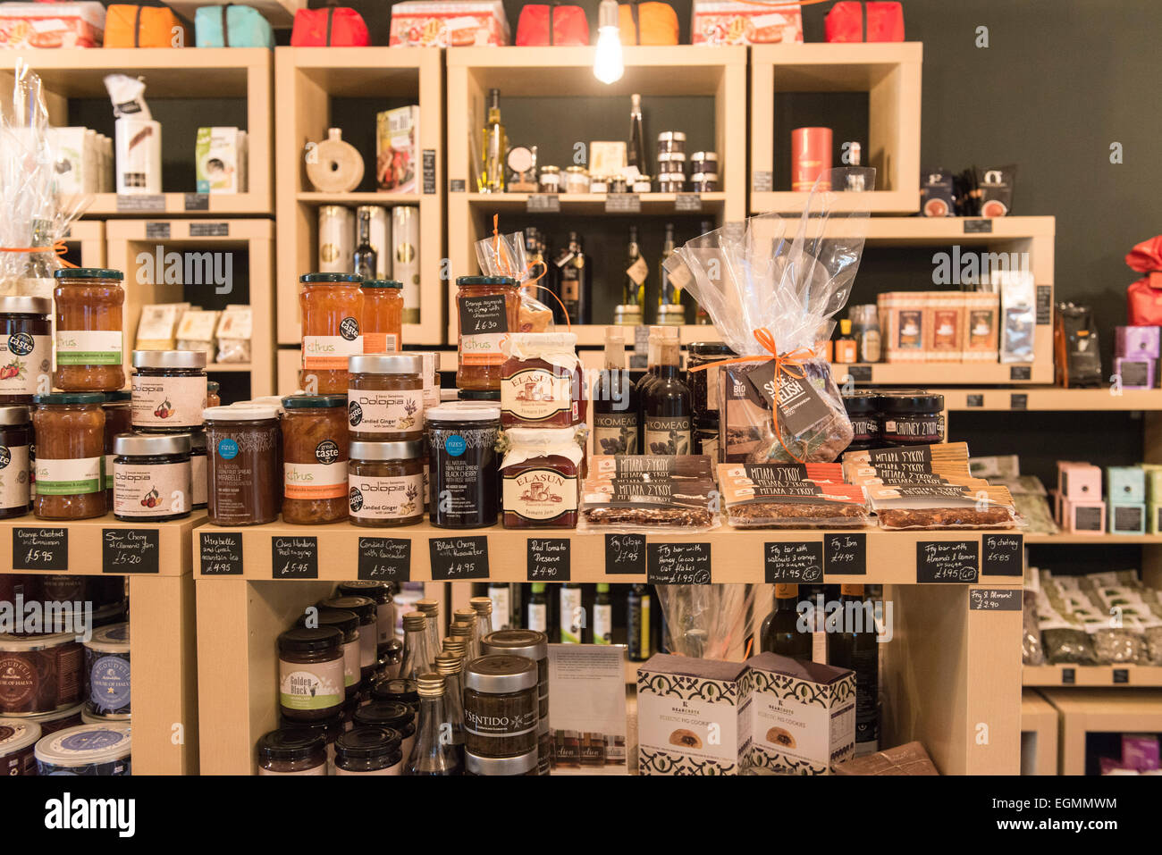 interior of posh luxury gourmet food and drink shop, showing the shelves packed with tasty food products like cheeses & jams etc Stock Photo