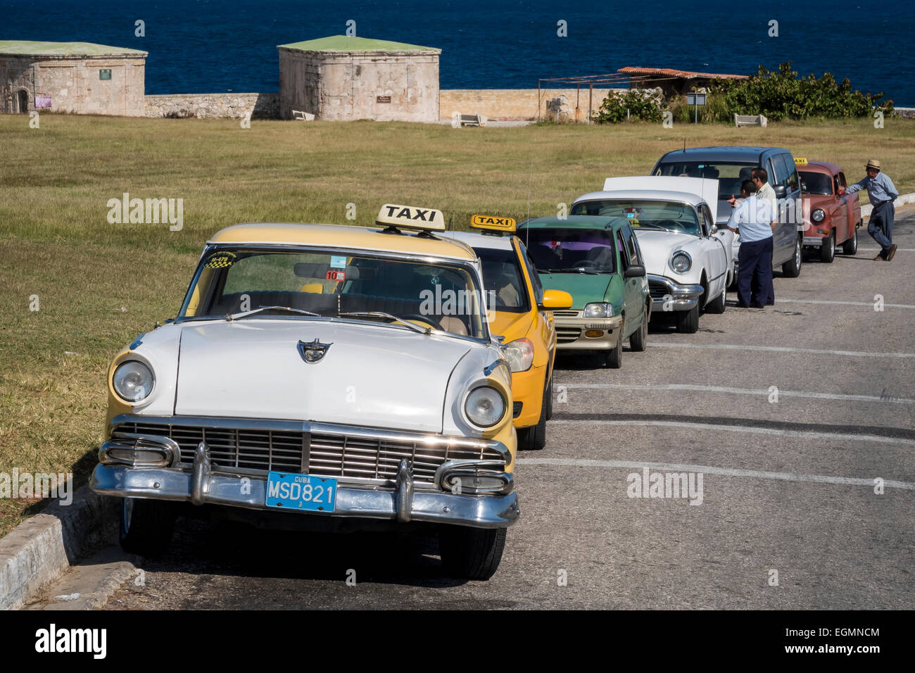 Classic 1950's America cars, often used as taxis on the road At the Castillo del Morro in Havana, Cuba. Stock Photo