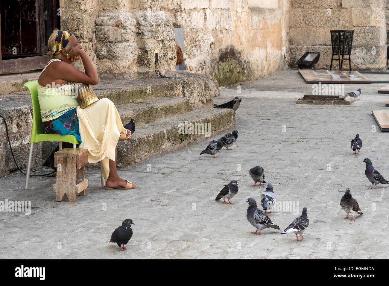 Local resident relaxing after feeding the pigeons in Plaza de San Francisco de Asis, Havana, Cuba Stock Photo