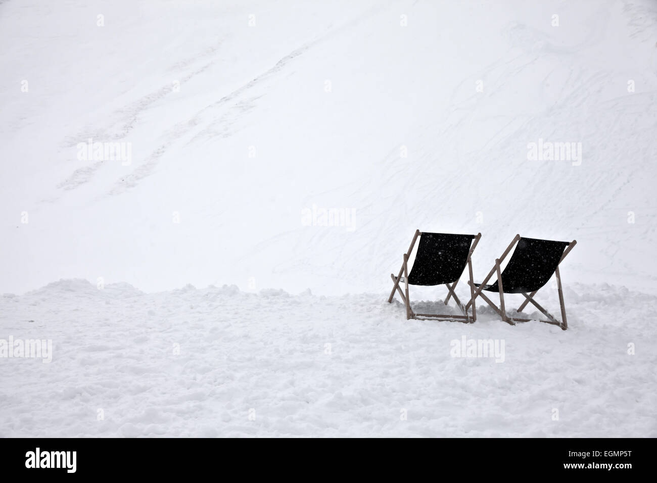 Two deck chairs in the snow, Mittenwald, Upper Bavaria, Bavaria, Germany Stock Photo