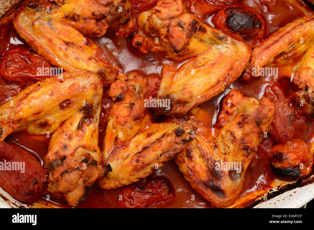 Chicken wings with spicy tomato sauce Stock Photo Alamy