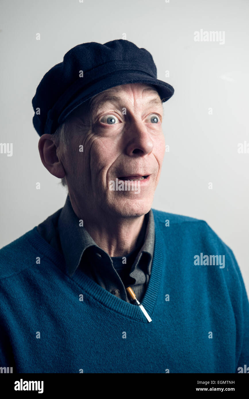 characterful funny old wise elder man in a peaked hat, v neck pullover