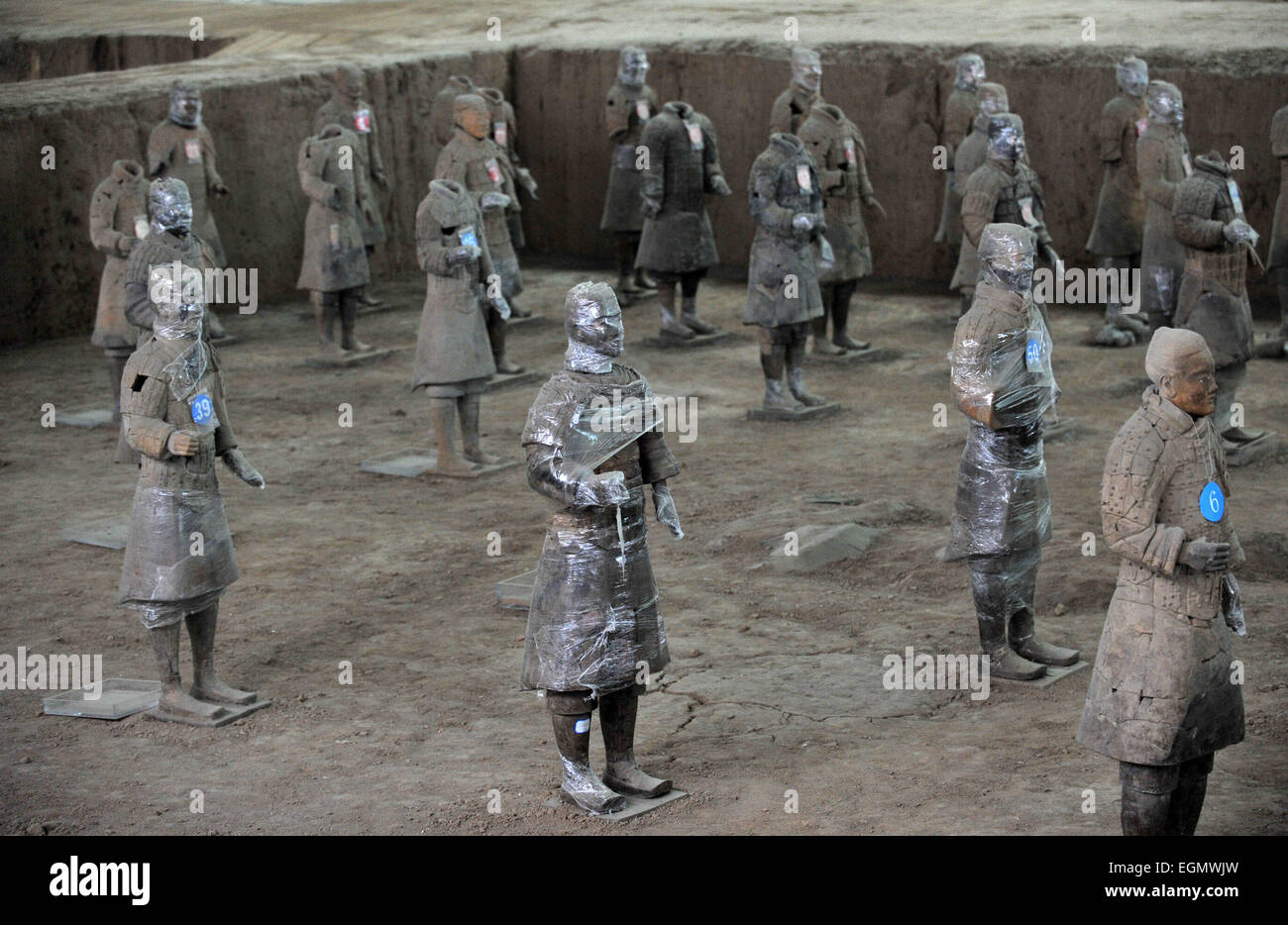 Xi'an. 27th Feb, 2015. Photo taken on Feb. 27, 2015 shows terracotta warriors wrapped in cling film for color fixing at the Emperor Qinshihuang's Mausoleum Site Museum in Xi'an, capital of northwest China's Shaanxi Province. According to experts at the Museum, wrapping terracotta warriors, a set of lifesize ancient Chinese army sculptures from the 3rd century B.C., in cling film has been in routine use for protection of remnant painting on these cultural relics. © Ding Haitao/Xinhua/Alamy Live News Stock Photo
