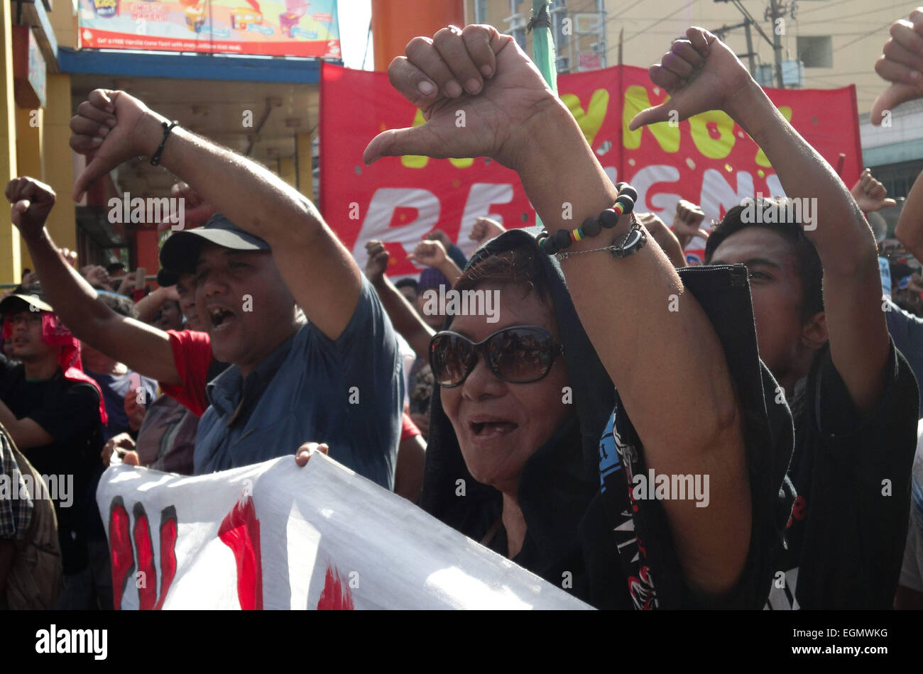 Manila, Philippines. 27th February, 2015. Protesters make the thumbs-down gesture during a rally at Mendiola Bridge near Malacanang Palace. The protesters are calling for the resignation of President Benigno Aquino III over the Mamasapano incident that resulted in the deaths of wanted Malaysian bombmaker Zulkifri 'Marwan' bin Hir, 44 police commandos, 18 Muslim rebels, and 8 civilians. Credit:  Richard James Mendoza/Pacific Press/Alamy Live News Stock Photo