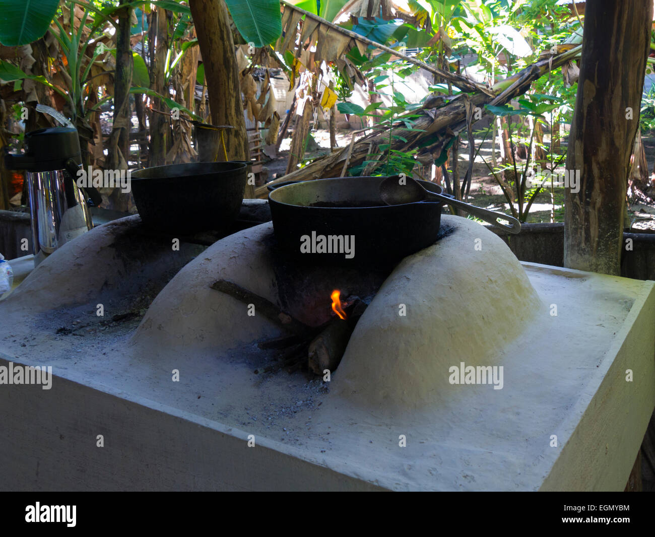 Cocoa beans cooking over a log fire to make a hot drink Dominican
