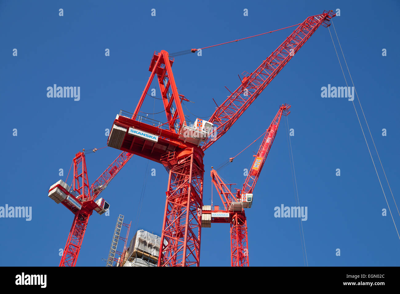 red Skanska cranes on construction site of Goldman Sachs bank's new European headquarters on Farringdon Street, London UK Stock Photo