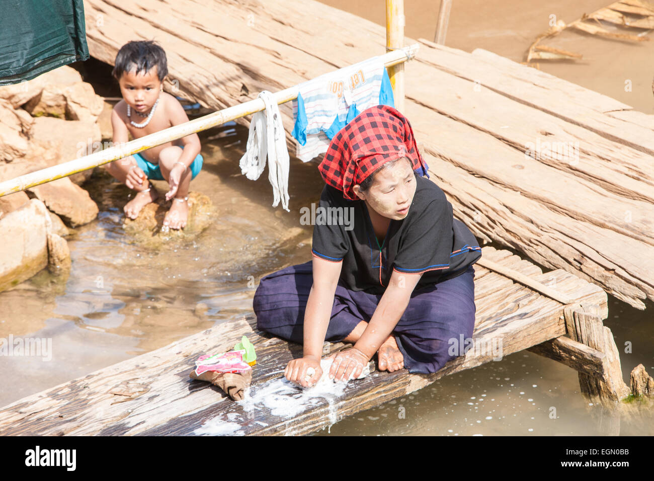 Woman washing clothes by hand hi-res stock photography and images - Alamy