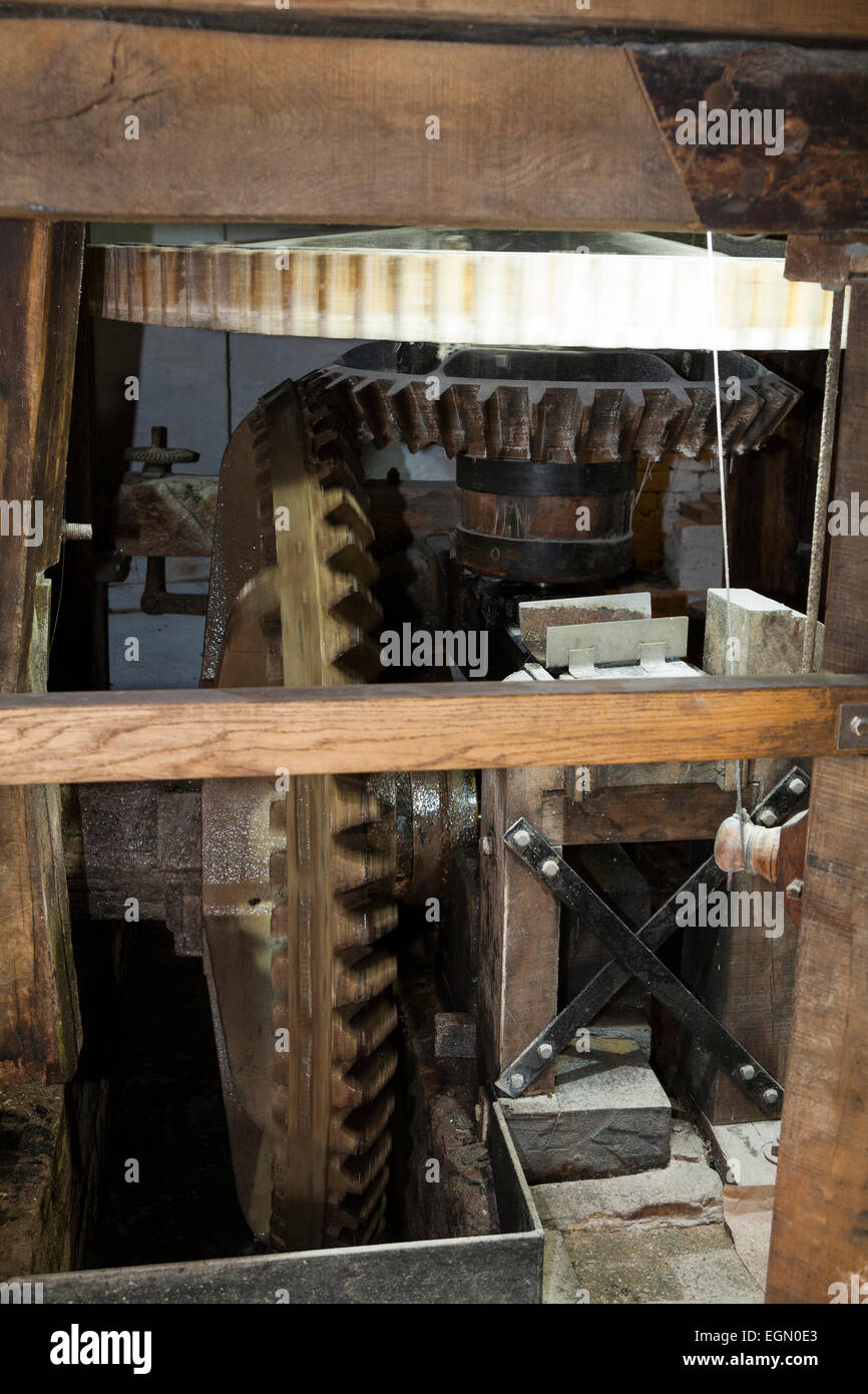 Water wheel gear turning spinning axle shaft / turns / spins / gears / turbine, at the Winchester Mill on River Itchen. UK. Stock Photo