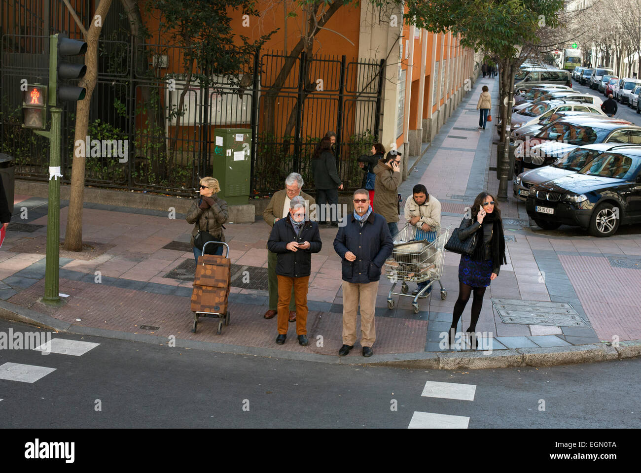 Waiting to cross the road people traffic lights Stock Photo