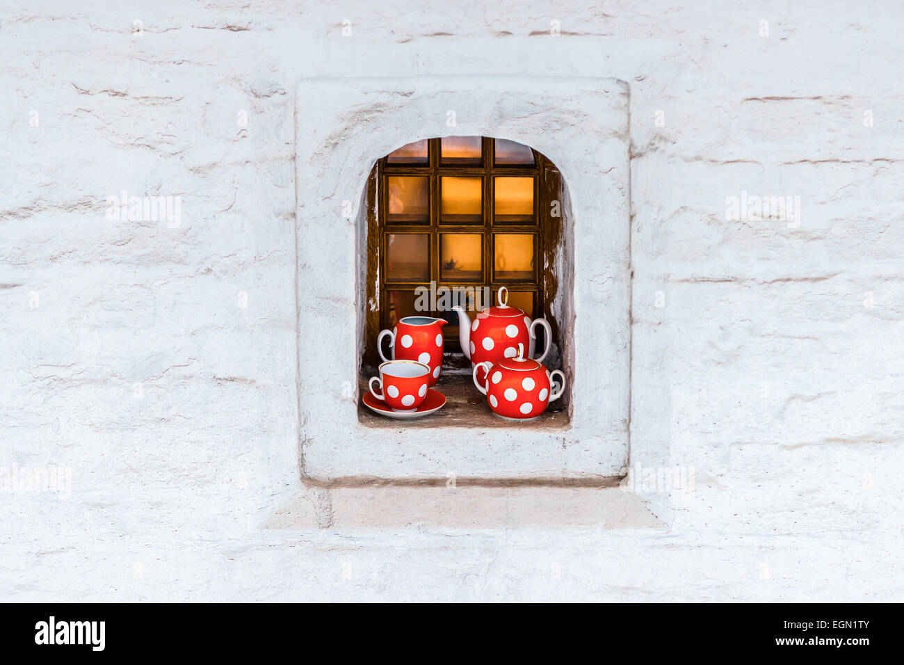 An elegant tea set in the window niche of a medieval building Stock Photo