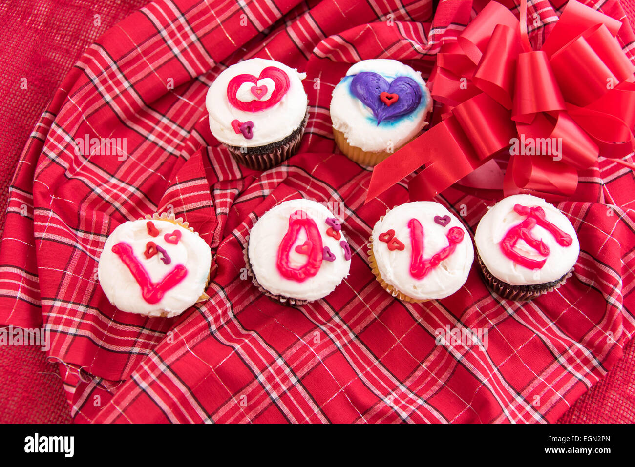 Valentines Day cupcakes with frosting letters spelling LOVE Stock Photo