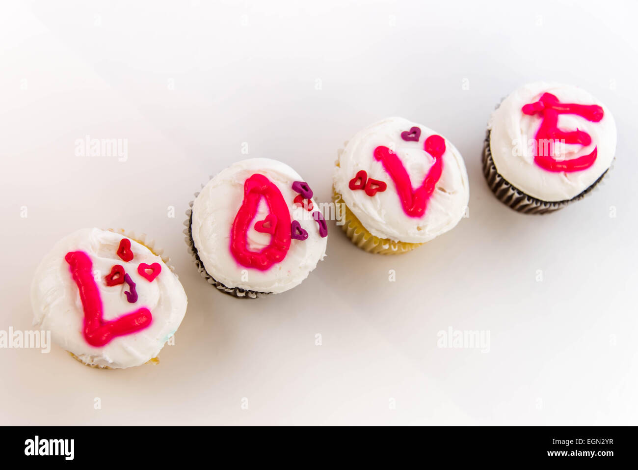 Valentines Day cupcakes with frosting letters spelling LOVE Stock Photo