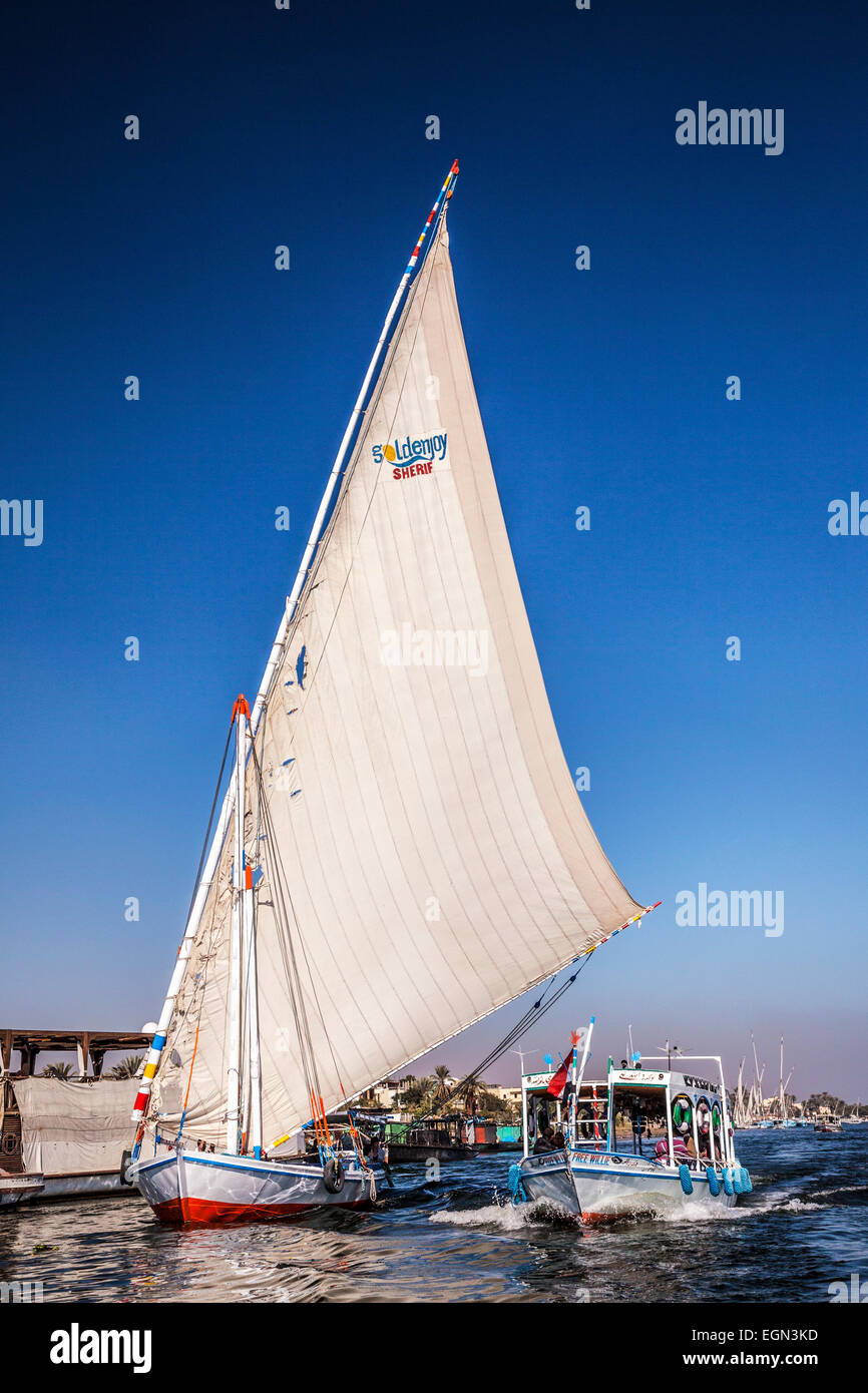 A ferry boat and felucca take tourists across the Nile at Luxor Stock ...