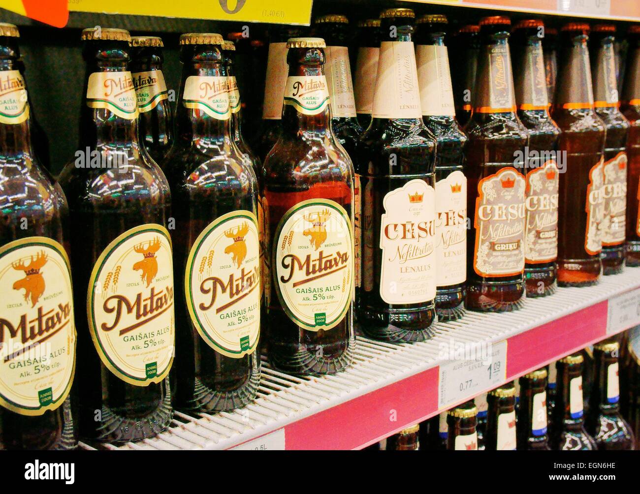Riga Latvia. Rimi hypermarket north city centre store.  Supermarket aisle displays. Alcohol Mitava Cesu beer bottle sales Stock Photo