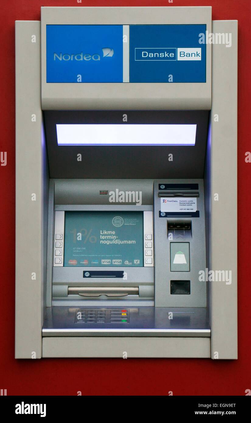 Riga Latvia. ATM cash dispenser automated teller machine cashpoint cashline on shopping street. Nordea Danske Bank Stock Photo