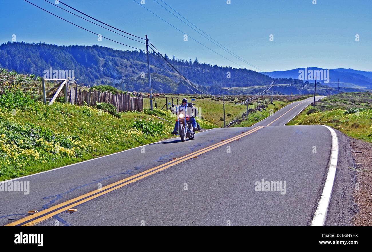 lone mortorcyclist rides on shoreline highway us 1 in sonoma county Stock Photo