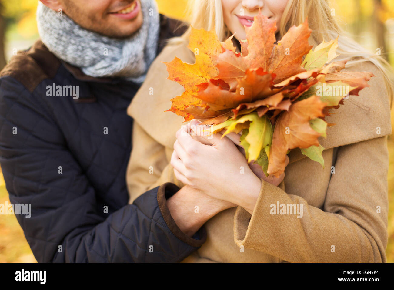 close up of smiling couple hugging in autumn park Stock Photo - Alamy