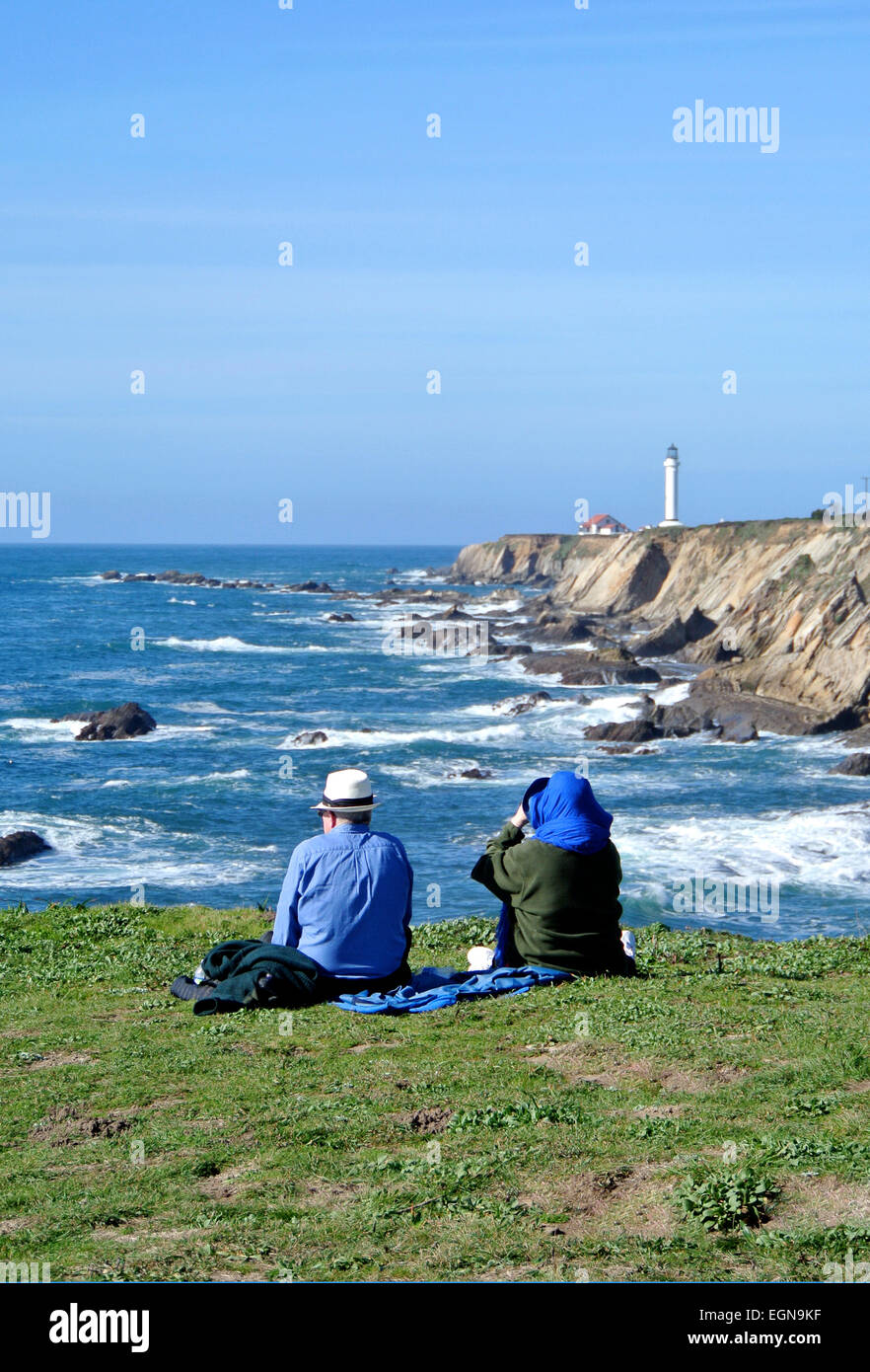 man and woman look for whales at the lighthouse lookout near fort bragg california on the Mendocino Coast Stock Photo