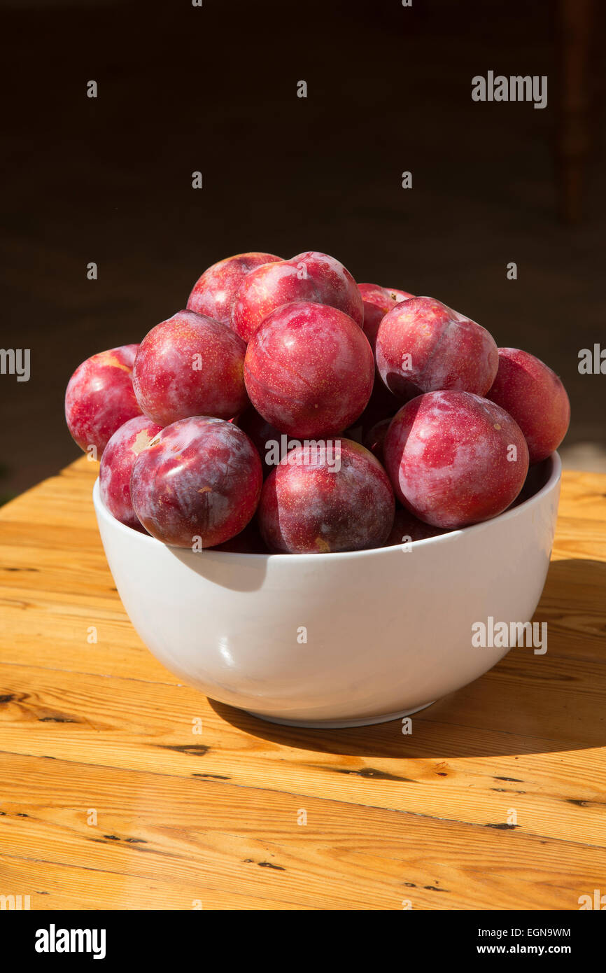 African delight sweet plums in a white bowl Stock Photo