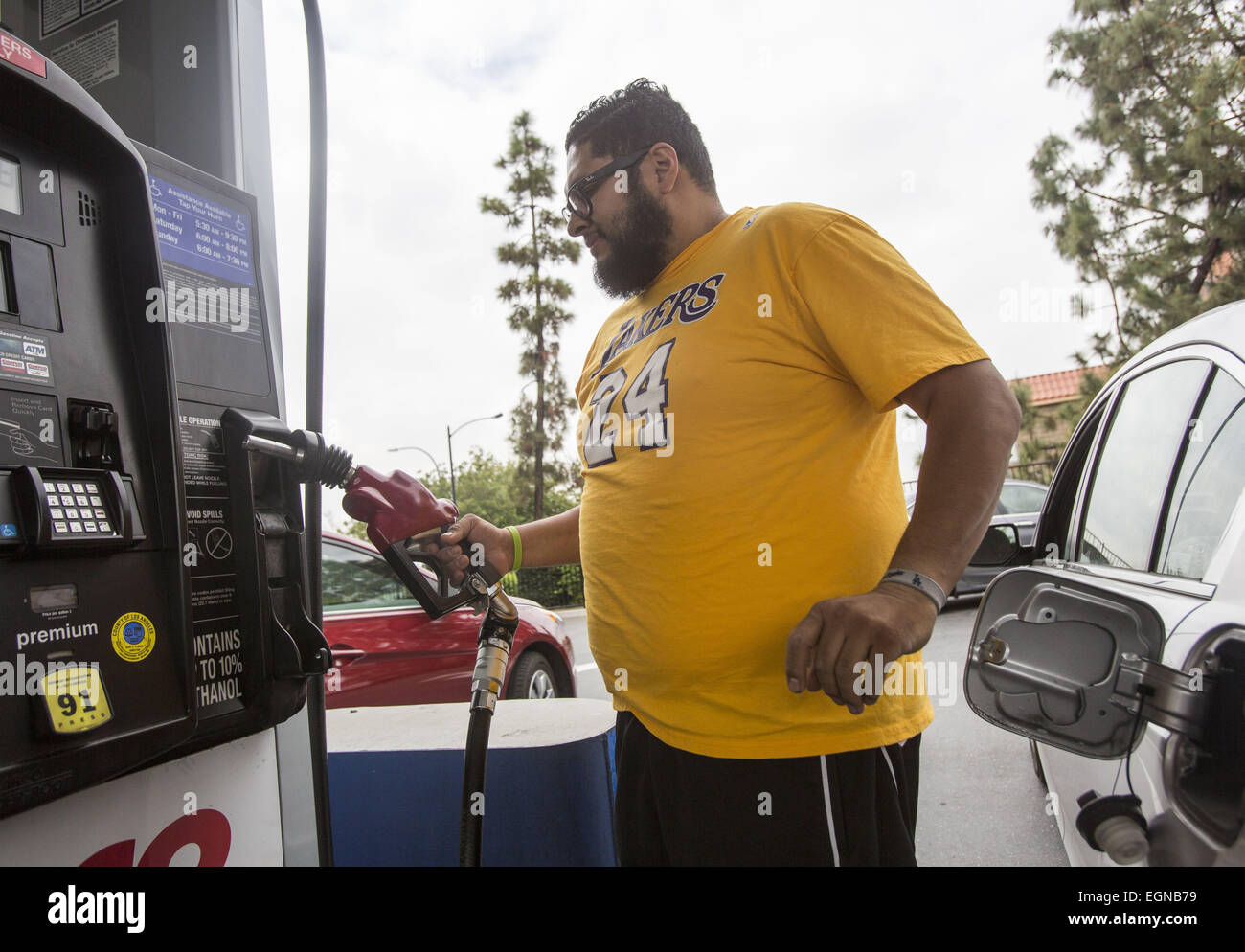 Feb. 27, 2015 - Los Angeles, California, U.S - A man fills up his car at a gasoline station in Los Angeles on Friday February 27, 2015. The average price of a gallon of self-serve regular gasoline in Los Angeles County today recorded its largest daily increase since.Oct. 6, 2012, rising 12.1 cents to $3.396, its highest amount since Oct. 28. The average price has increased 28 consecutive days, rising 90.7 cents, including 8 cents on Thursday, according to figures from the AAA and Oil Price.Information Service. (Credit Image: © Ringo Chiu/ZUMA Wire) Stock Photo