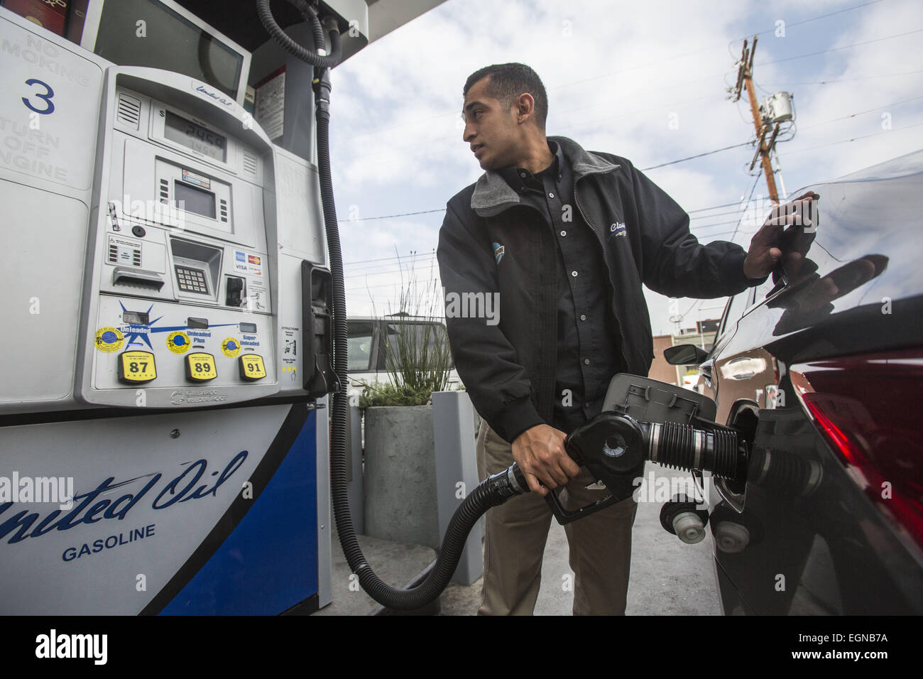 Feb. 27, 2015 - Los Angeles, California, U.S - A man fills up his car at a gasoline station in Los Angeles on Friday February 27, 2015. The average price of a gallon of self-serve regular gasoline in Los Angeles County today recorded its largest daily increase since.Oct. 6, 2012, rising 12.1 cents to $3.396, its highest amount since Oct. 28. The average price has increased 28 consecutive days, rising 90.7 cents, including 8 cents on Thursday, according to figures from the AAA and Oil Price.Information Service. (Credit Image: © Ringo Chiu/ZUMA Wire) Stock Photo