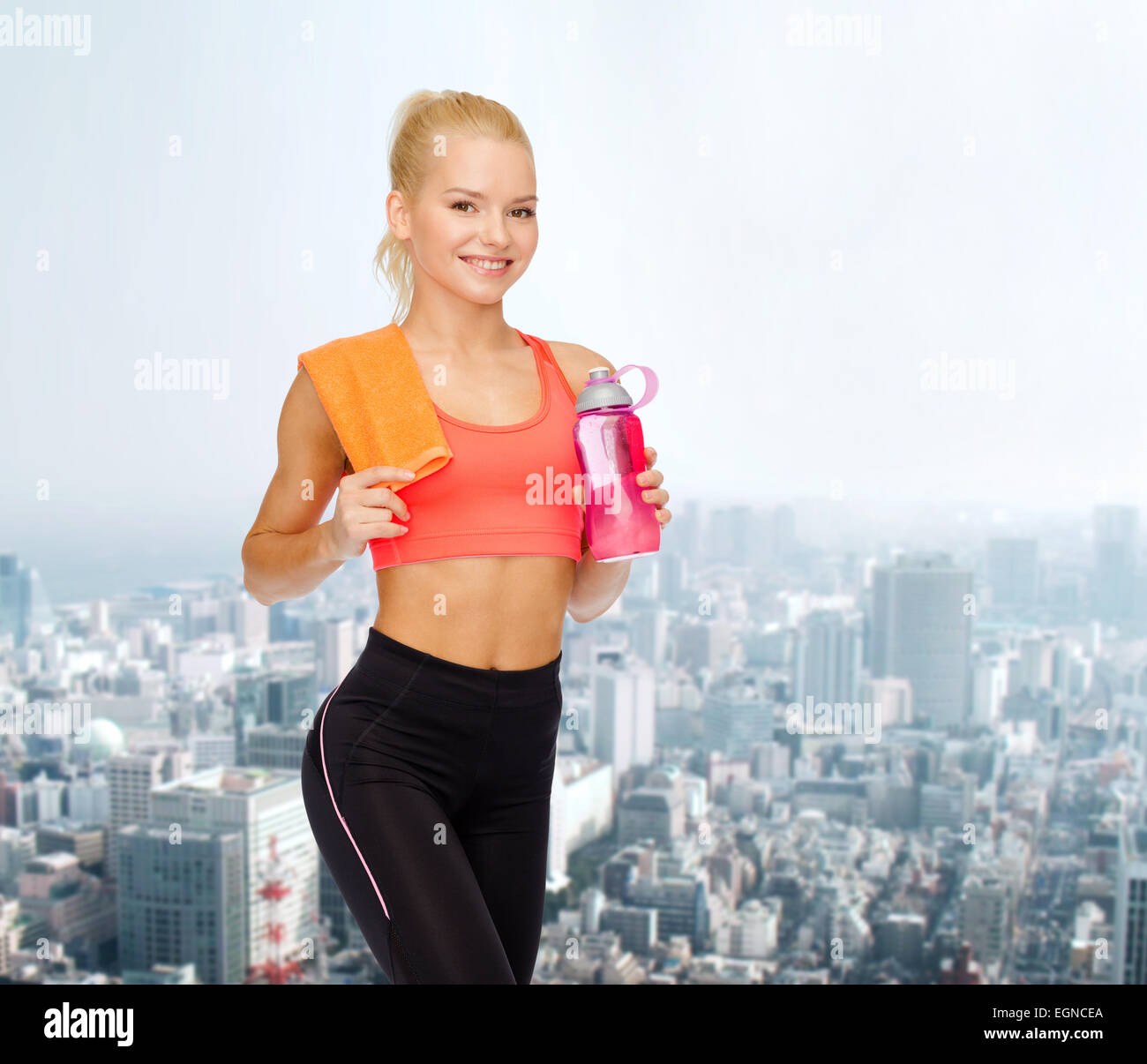 smiling sporty woman with water bottle and towel Stock Photo - Alamy