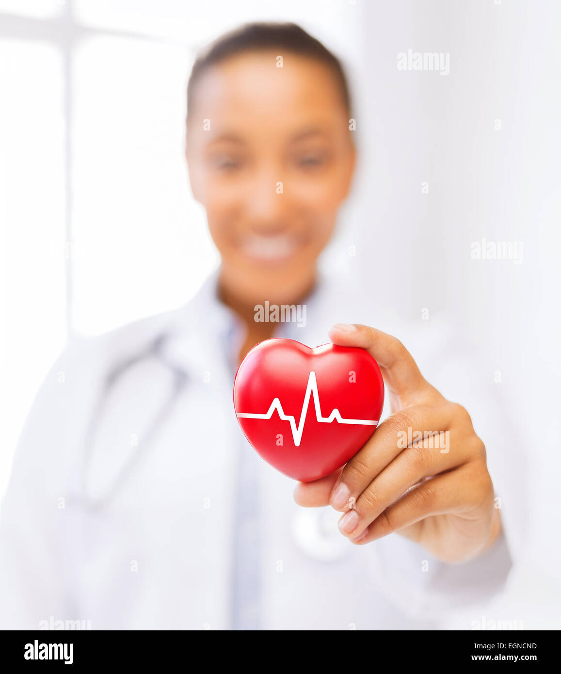 female doctor holding red heart with ecg line Stock Photo - Alamy