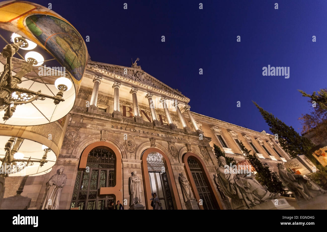 Stairs and main entrance with monuments of the Biblioteca Nacional de España (National Library of Spain) at night. Stock Photo