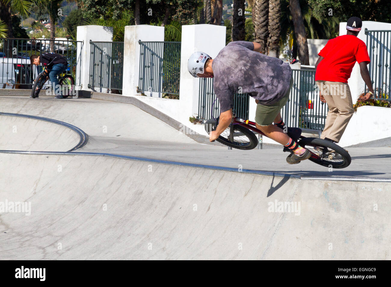 A boy making a stunt jump on his bike at a skate park in Santa Barbara, California. Stock Photo