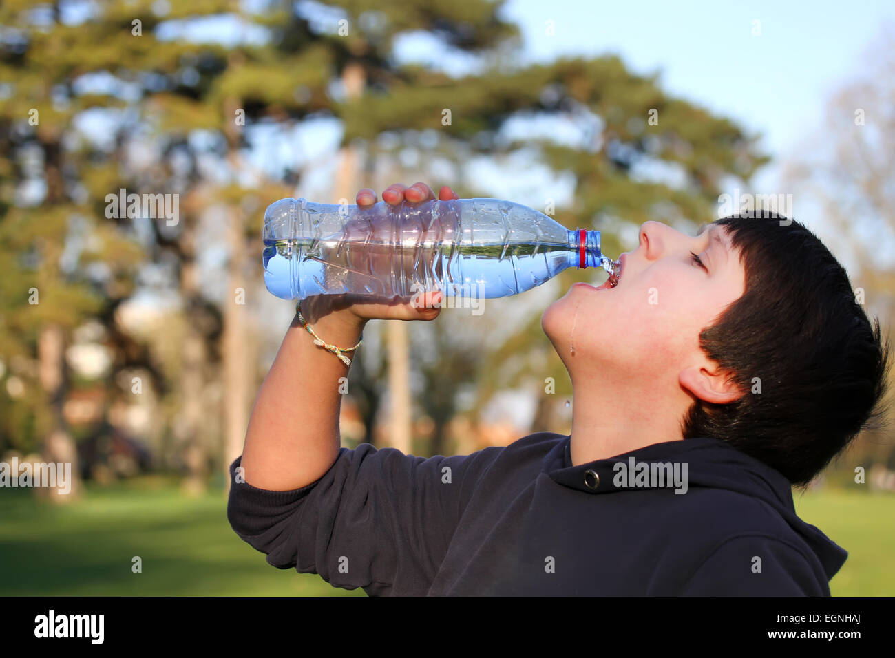 A Boy Thirsty Eagerly Drinking Water From Plastic Bottle Stock Photo Alamy