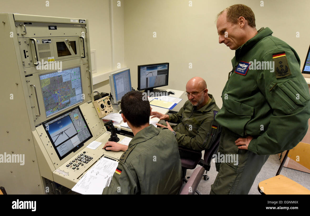 Jagel, Germany. 17th Feb, 2015. Commander Michael Krah (r) talks to fighter pilot as he trains how to steer and fly a drone in Jagel, Germany, 17 February 2015. It is for the first time that soldiers in germany are being trained how to fly an unmanned drone. Theoretical training takes place in front of a simulatoir in Kropp. Practical training continues at a llater stage in Israel. Photo: Carsten Rehder/dpa/Alamy Live News Stock Photo