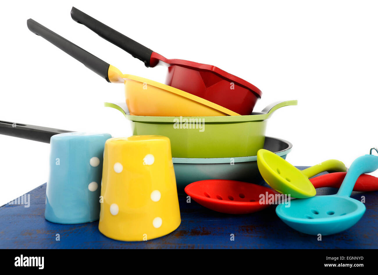 Bright colorful modern kitchen pot and pans in red, yellow, blue and green  theme with spoons and salt and pepper shakers, on dar Stock Photo - Alamy