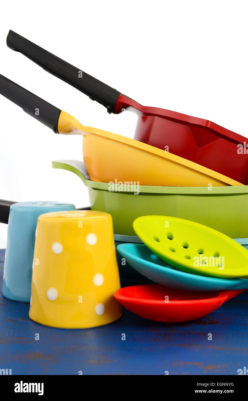 Bright colorful modern kitchen pot and pans in red, yellow, blue and