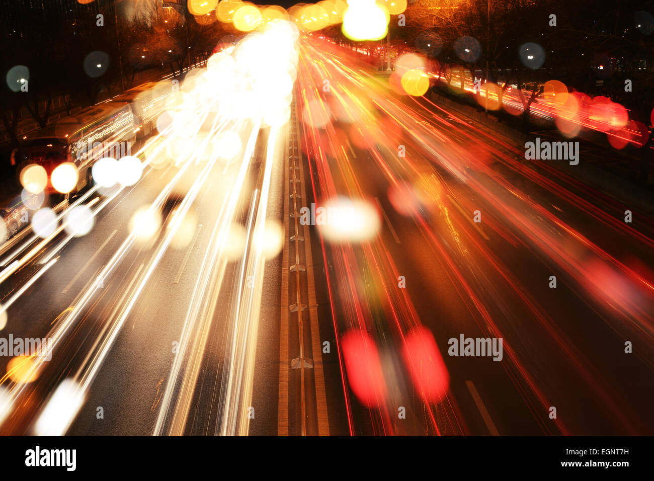 Road at night with traffic trails and blurred lights Stock Photo